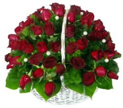 Round wicker basket with 80 red rose branches decorated with pearls