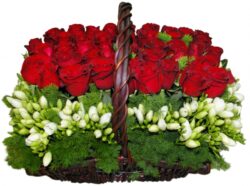 Rectangular wicker basket with red roses and freesia